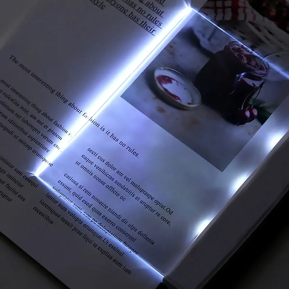 Flat panel LED book reading light providing page illumination