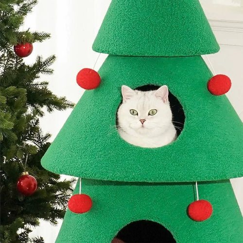 Green cat tree shaped like a Christmas tree with red ornaments and a white cat peeking out.