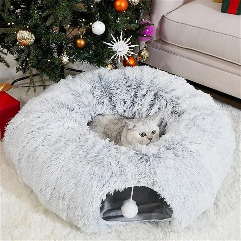 Soft gray collapsible cat tunnel bed with plush donut design and hanging pom-pom toy, providing a cozy hideaway and play space for cats