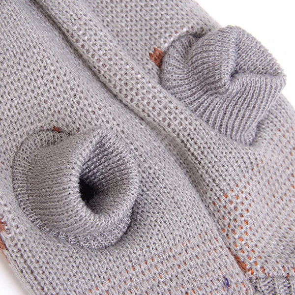 Festive knitted dog sweater close-up - gray texture and decorative detail
