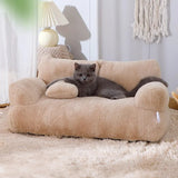 Gray cat relaxing on beige plush cat bed sofa with backrest and side pillows, cozy winter nest for cats and small dogs in a modern home setting.