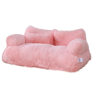 Pink plush cat bed sofa with backrest and side pillows, soft and cozy winter nest for cats and small dogs.