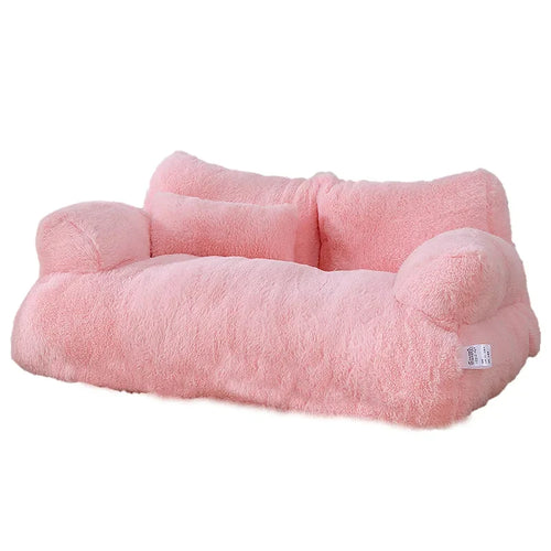 Pink plush cat bed sofa with backrest and side pillows, soft and cozy winter nest for cats and small dogs.