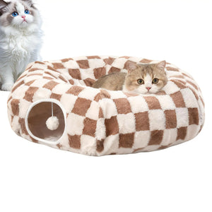 Two cats with a brown and white checkerboard donut cat tunnel cave bed with hanging toy ball, cozy velvet indoor cat bed for play and naps.