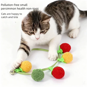 Cat playing with tomato and persimmon plush ball cat teaser string toy with bell, non‑toxic interactive cat toy for indoor cats to catch and bite.