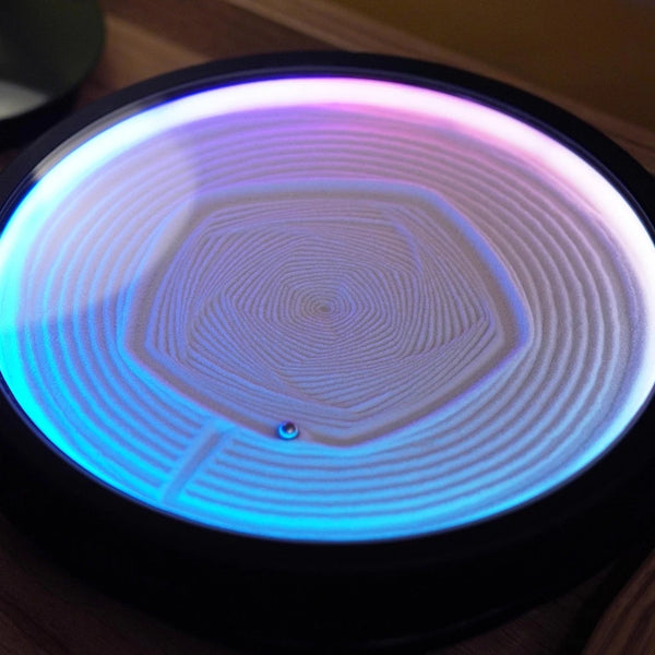 ound LED zen sand lamp with blue and purple gradient light and concentric hexagon sand pattern on a black base