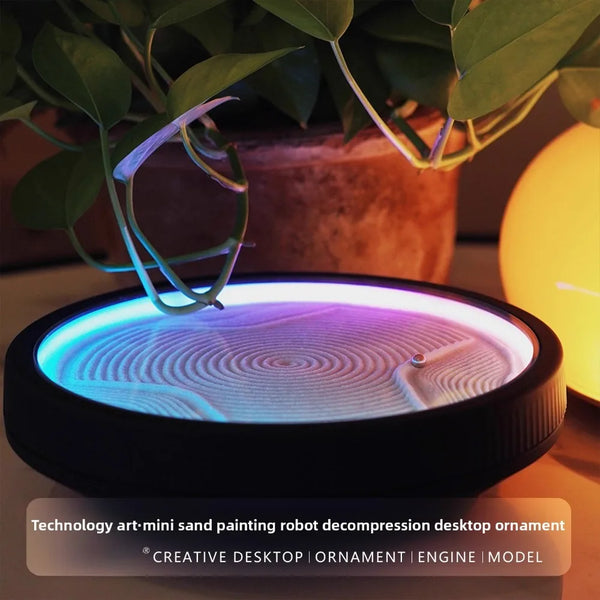 LED zen sand lamp with glowing blue and purple light on a desk, styled with green plant and warm ambient lamp