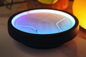LED zen sand lamp with blue and warm gradient light creating circular sand patterns on a desk with soft ambient lighting